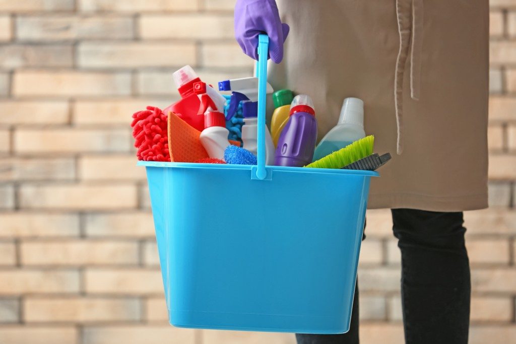 blue bucket with cleaning agents and materials