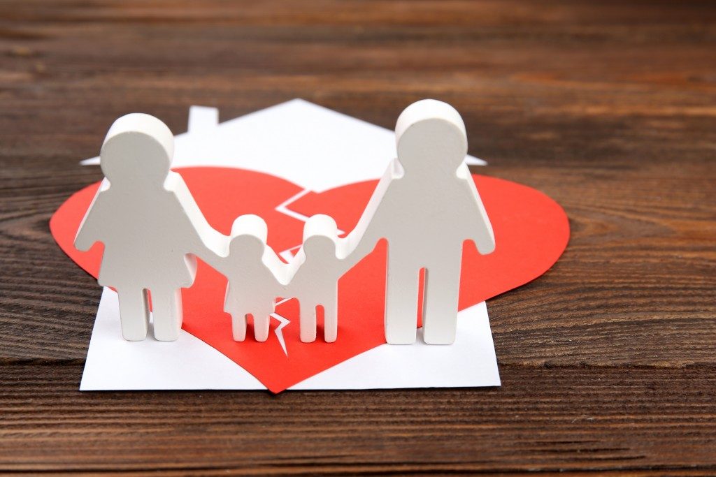 divorce and child custody concept with a broken heart on top of family's house