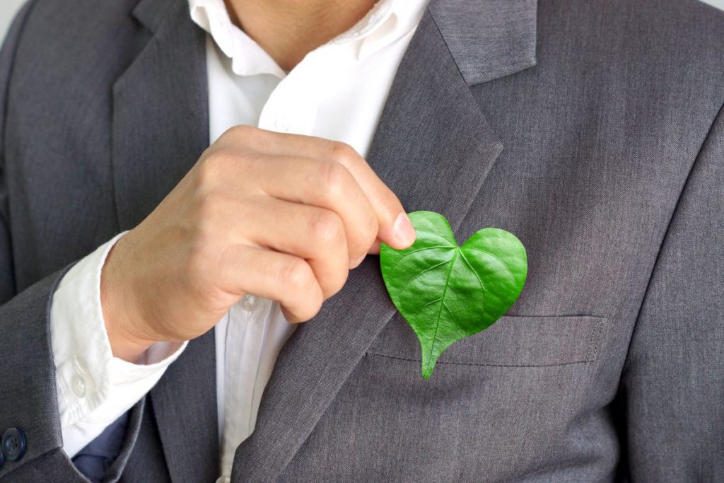 heart shaped leaf held by man