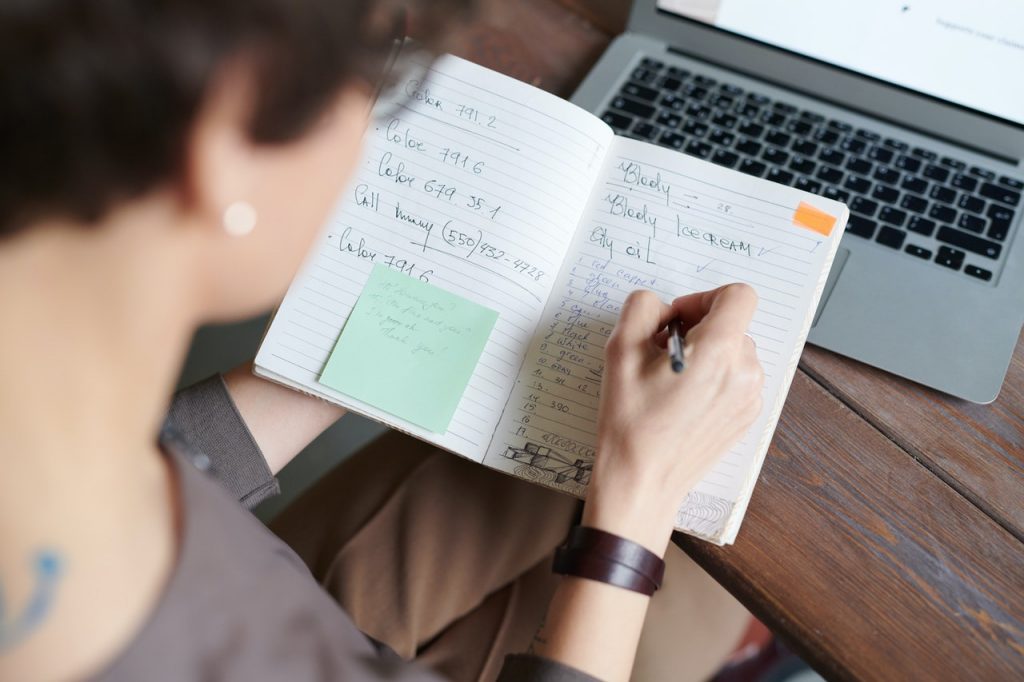 woman taking down notes