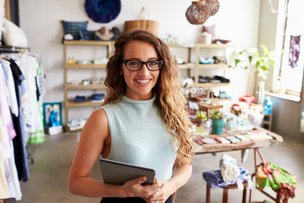 woman smiling with her business behind