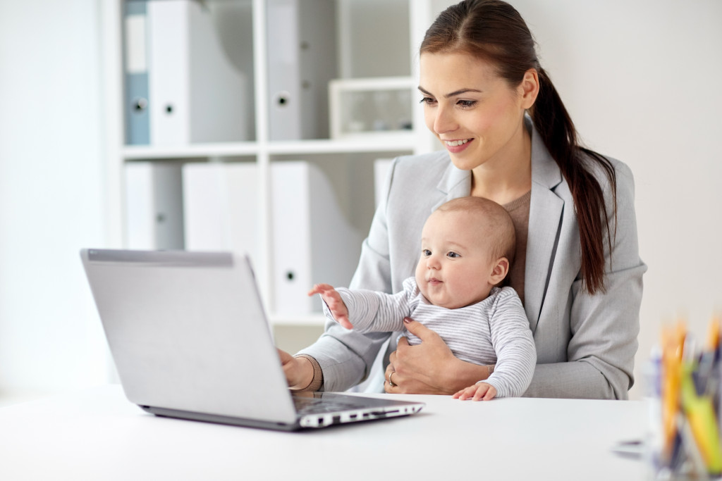 A woman working at home with her baby