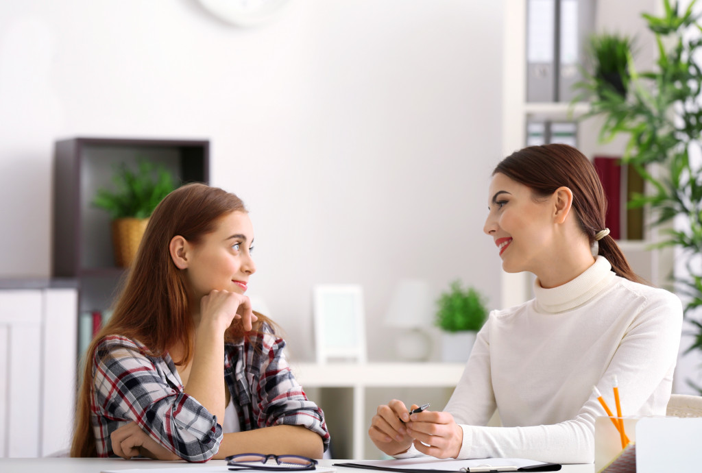 woman happily talking with another woman