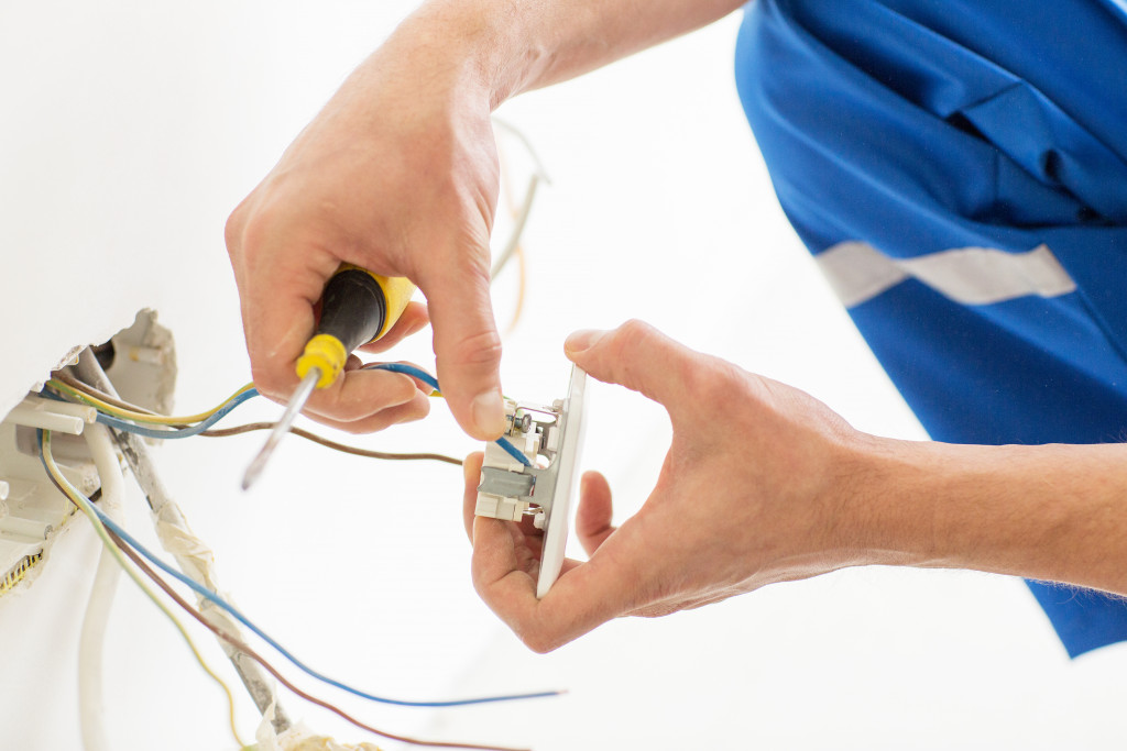 An electrician fixing an electric wiring