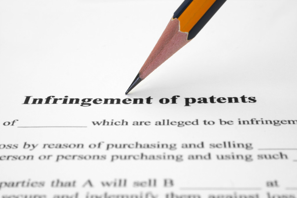 An infringement of patents document and a pencil
