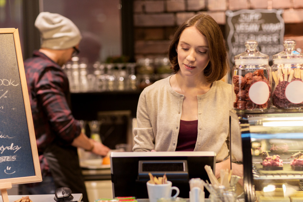 Female business owner checking inventory on a computer.