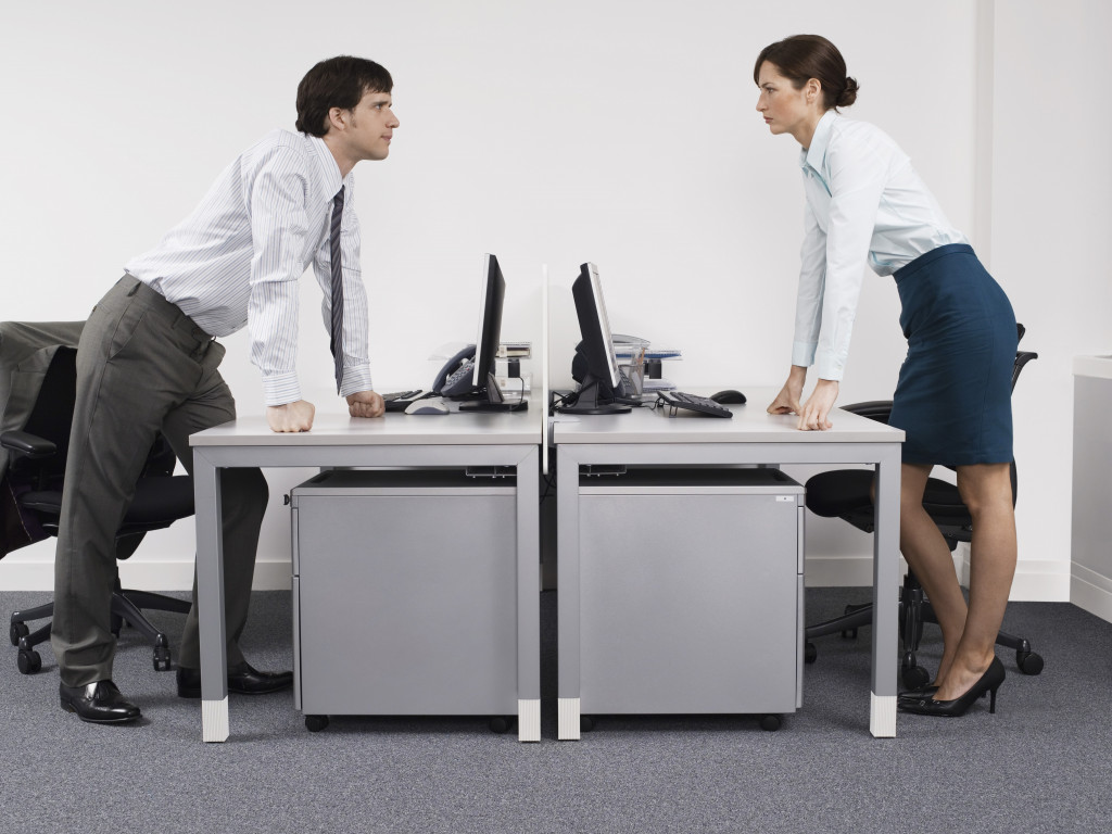 male and female office worker in a fight at the office